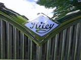 Riley RMB badge.  2Ã‚Â½litre cars had this sky blue badge.